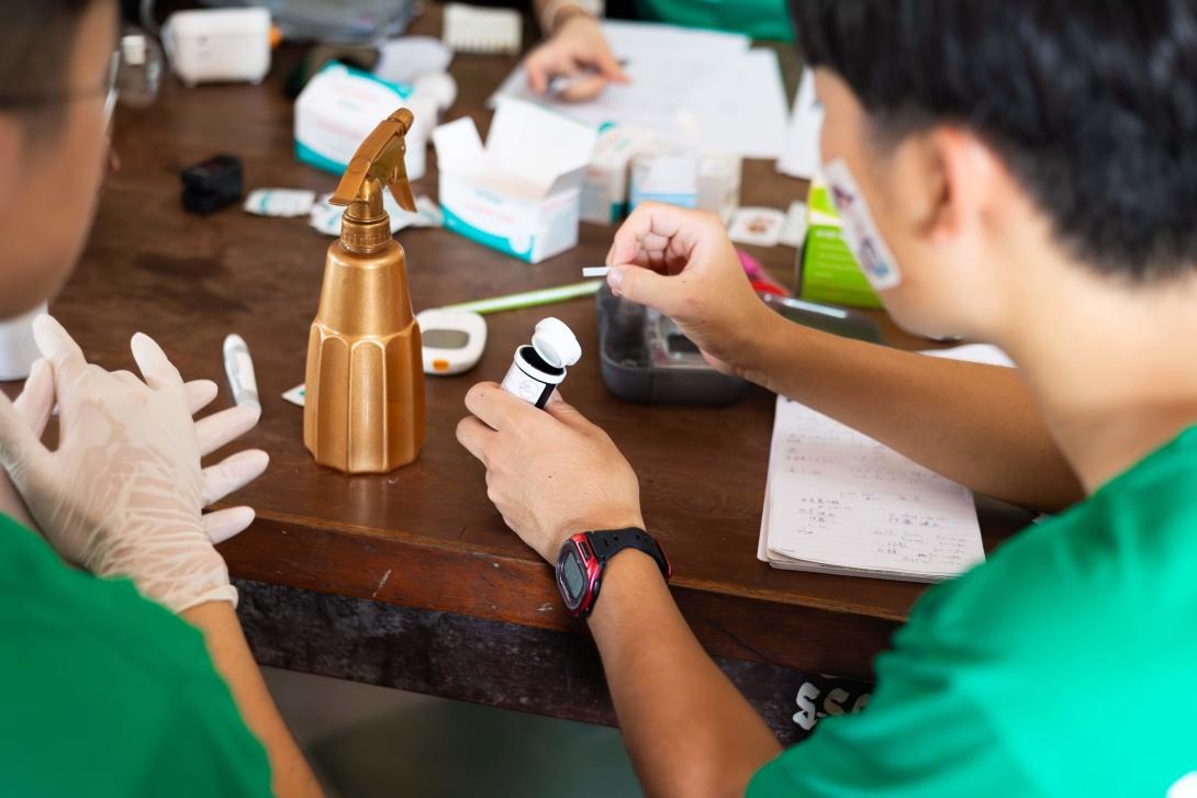 Healthcare intern learning how to conduct medical outreach checks and measure vital signs